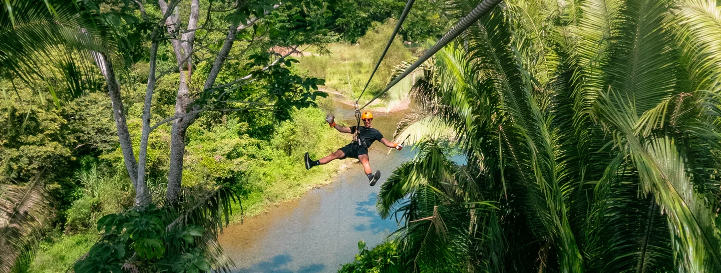 A Watermark Belize Hotel Guest ziplines in the Belizean jungle