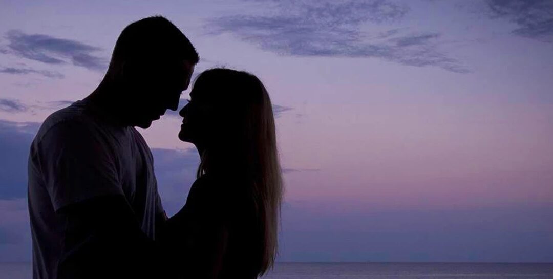 Watermark Belize Hotel couple on a honeymoon at sunset on the rooftop Skyview Restaurant San Pedro Ambergris Caye